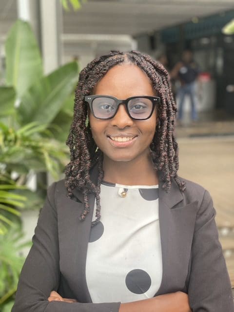 A woman with glasses and a black jacket