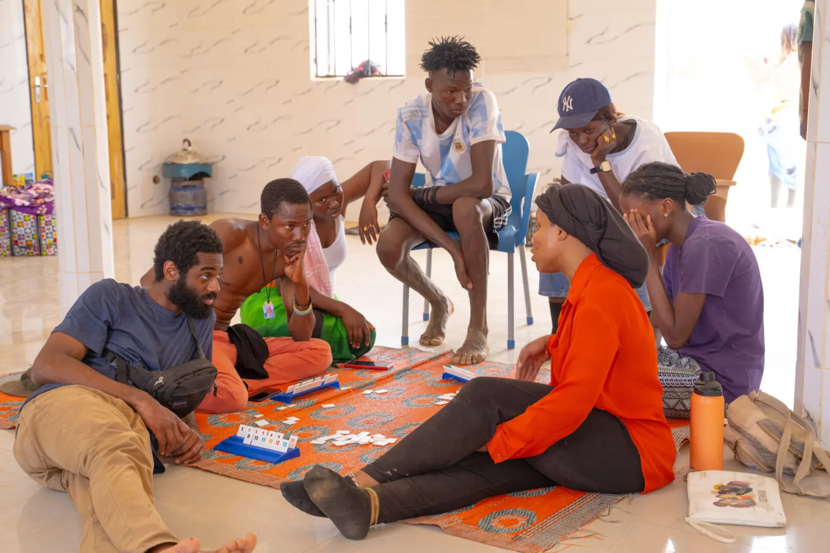A group of people sitting on the floor playing a game.