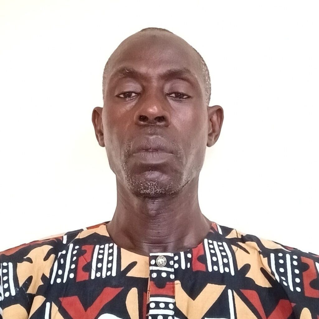 A man in an african print shirt.